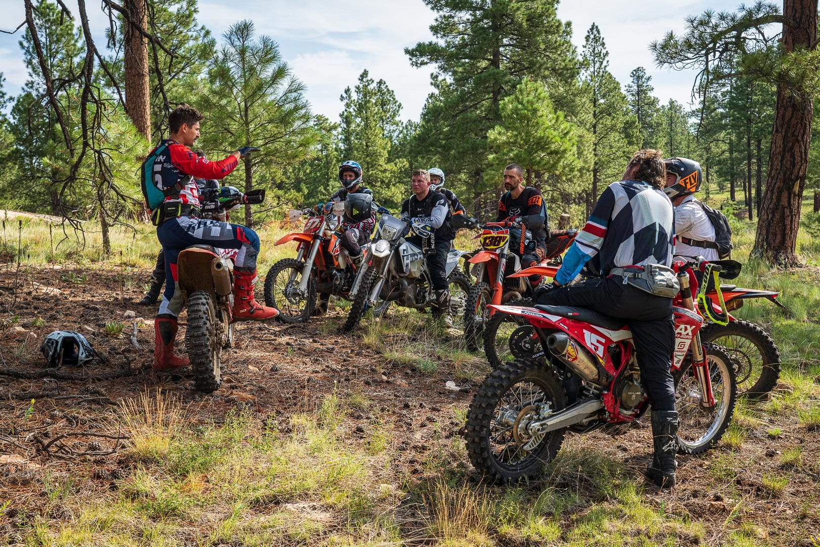 The Coconino Trail Riders meeting in the woods with motorcycles for seats